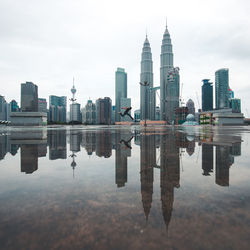 Digital composite image of modern buildings against sky