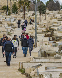 Rear view of people walking on staircase