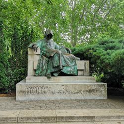 Statue against trees and plants