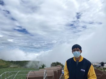 Portrait of man standing against sky