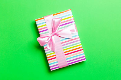 Gift box on colored background top view with copy space. holiday concept.