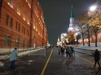 People walking in city at night