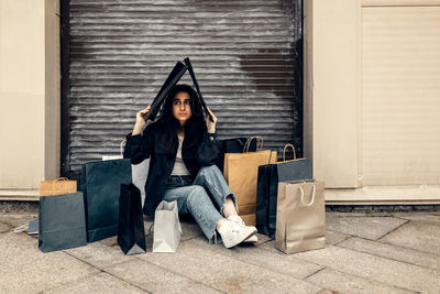 Happy young woman rejoices in good shopping. girl with shopping bags.