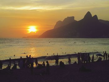 Silhouette of people on beach during sunset