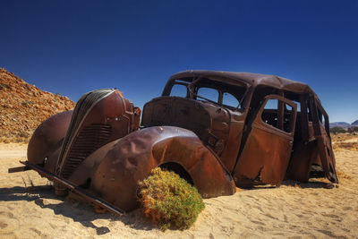 Rusty and abandoned car in the desert of namib