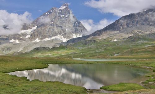 Scenic view of lake and mountains against sky