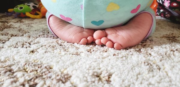 Low section of baby on carpet