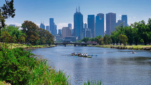 Scenic view of river and buildings against sky