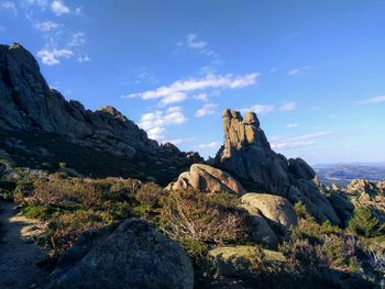 Rock formations on landscape against sky