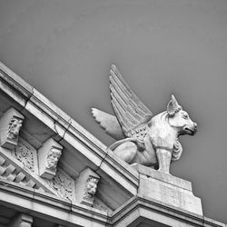 Low angle view of statue against building