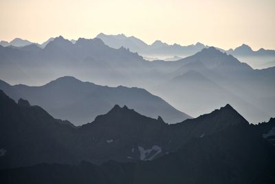 Scenic view of mountains against sky at sunset