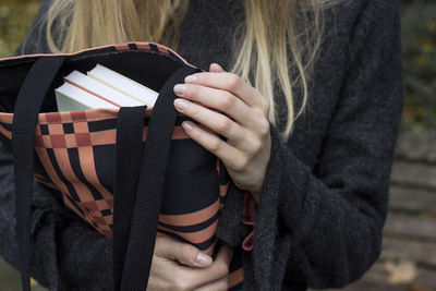 Midsection of woman holding umbrella