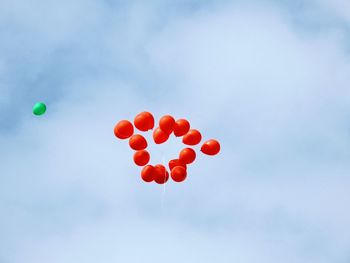 Low angle view of balloons against sky