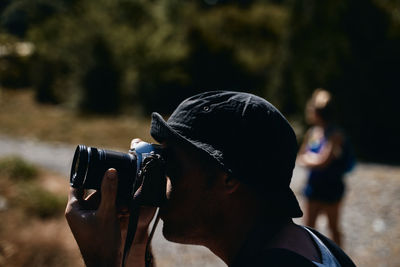 Portrait of woman photographing outdoors