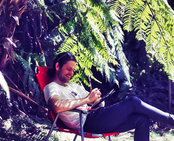 Young man sitting outdoors