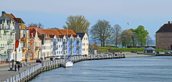 View of houses in city against clear sky