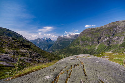 Scenic view of mountains against blue sky