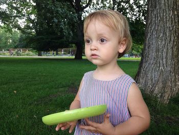 Portrait of young woman standing on grass