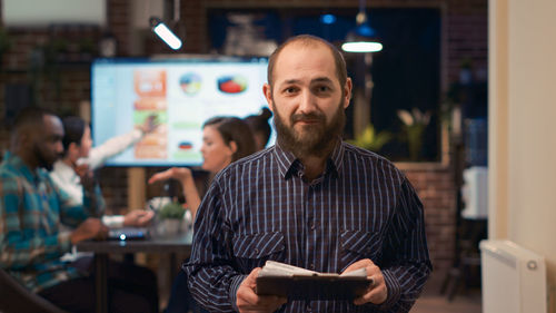 Portrait of young man standing in store