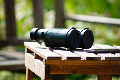 Close-up of camera on table in forest