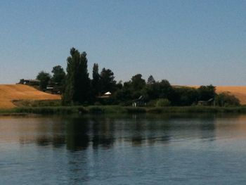 Scenic view of calm lake against clear sky