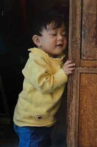 Cute boy looking at entrance to door