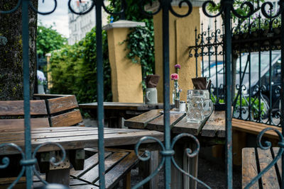 Empty chairs and table in yard against building