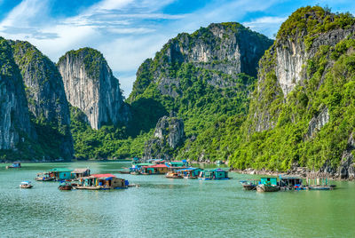 Panoramic view of boats on rocks against sky