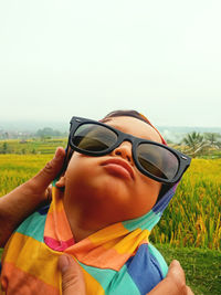 Portrait of man wearing sunglasses on field