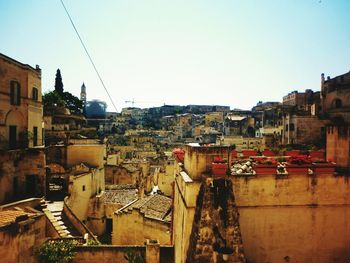 Houses in city against clear sky