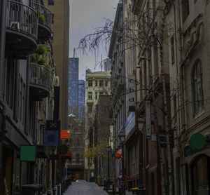 Street amidst buildings in city against sky