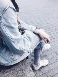 Low section of man sitting outdoors