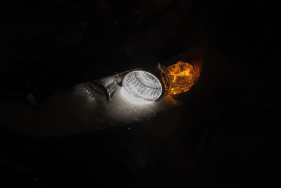 High angle view of illuminated lamp against dark background