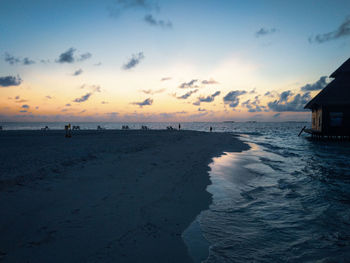 Scenic view of beach against sky during sunset