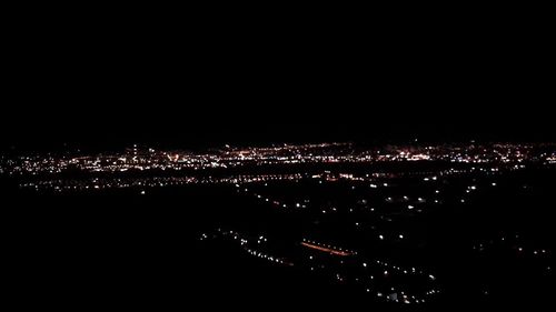 High angle view of illuminated buildings in city at night