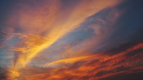 Low angle view of cloudy sky at sunset