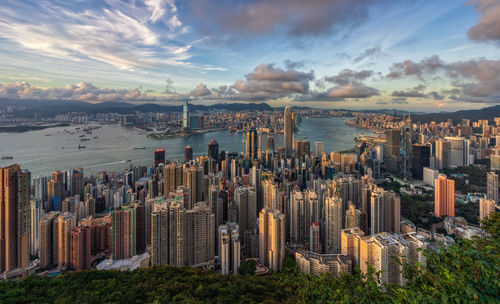 Aerial view of buildings against cloudy sky