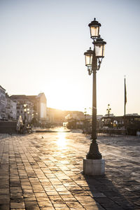 Street light in city during sunset