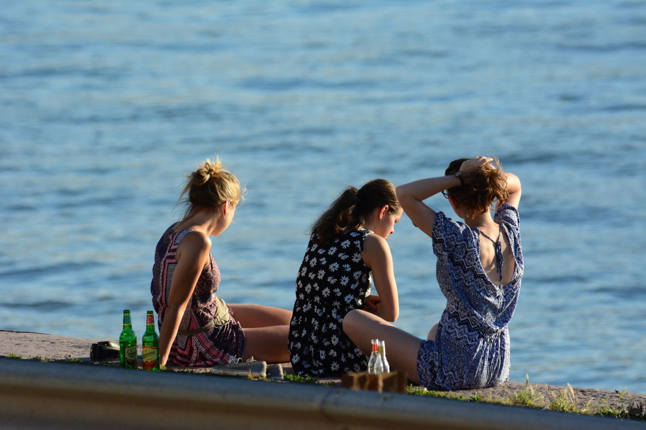 water, real people, leisure activity, young women, sea, young adult, casual clothing, togetherness, standing, day, outdoors, friendship, lifestyles, nature, full length, beauty in nature