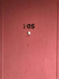 Full frame shot of red door with text on wall