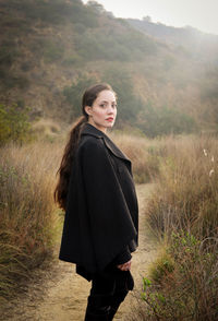 Young woman standing on field