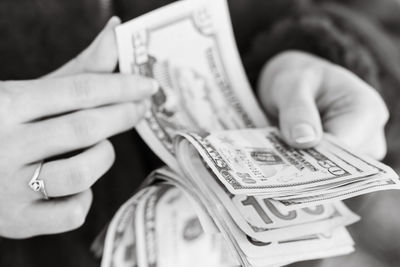 Midsection of man holding paper currency