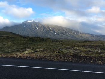 Empty road with mountains in background