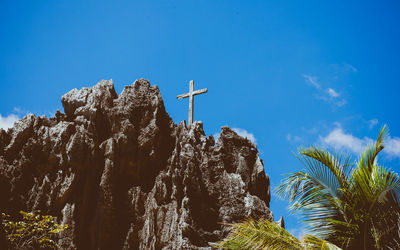 Low angle view of trees against clear blue sky