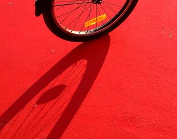 Close-up of bicycle on red wall