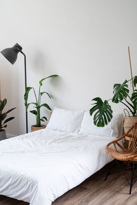 Space at home with bed, monstera and laundry baskets