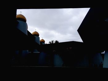 Low angle view of silhouette trees against sky