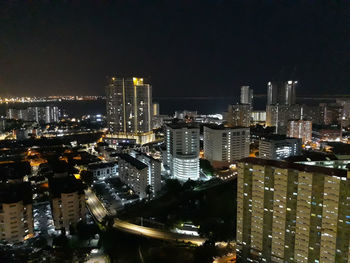 High angle view of illuminated city buildings against sky