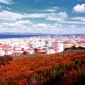 Cityscape against cloudy sky