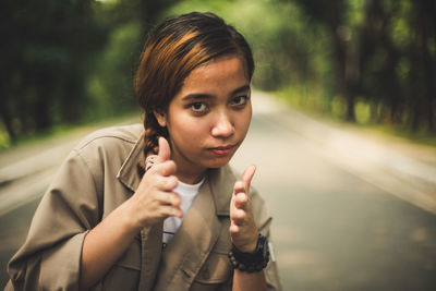 Portrait of teenage girl standing on road